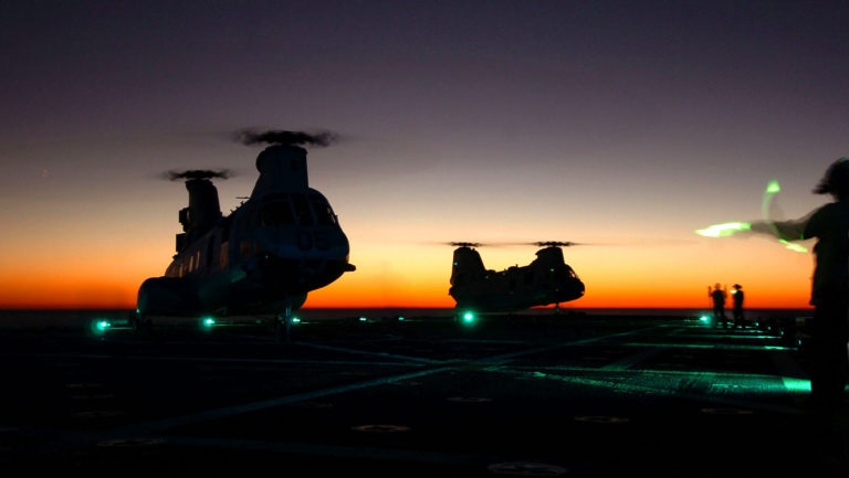 Two CH-46 Sea Knight helicopters land on the flight deck of the amphibious docking ship USS Shreveport (LPD 12) during night operations in the Atlantic Ocean on Oct. 29, 2006. Shreveport is conducting a component unit exercise in preparation for an upcoming deployment. DoD photo by Seaman Recruit Chad R. Erdmann, U.S. Navy. (Released)
